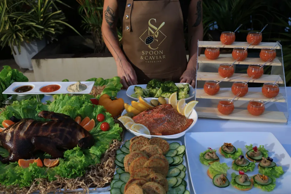 Spoon & Caviar private event catering table in Metro Manila styled with canapés, grilled fish, salads and sauce flights