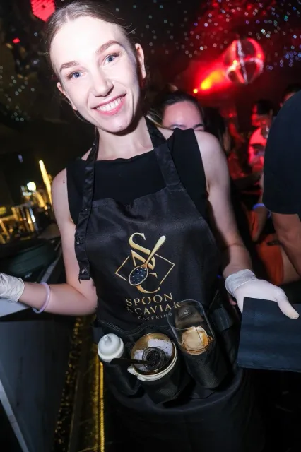 Spoon & Caviar server carrying a branded caviar tray at a Manila event